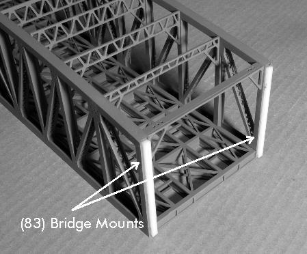 Next you will mount the bridge between the towers. Glue the 1/8" acrylic bridge mounts (83) x 4 between the flanges of the I beams on the ends of the bridge.
