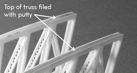 The truss top (13) is shorter than the truss bottom (14).