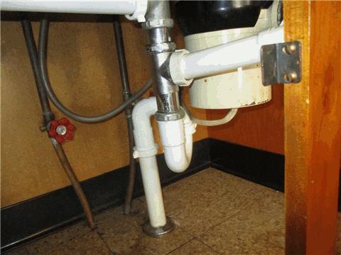 The visible areas of the plumbing under the kitchen sink appeared to be in serviceable condition at the time of the