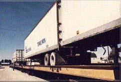 Figure 3-8 Trailer on Flat Car Trailer on Flat Car TOFC) service, which allows rail cargoes to be delivered on wheels directly to a destination even if not on a rail spur, is a post World War II