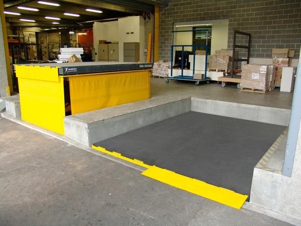 The scissor lift may be mounted into a recessed pit in the floor slab or dock bank.