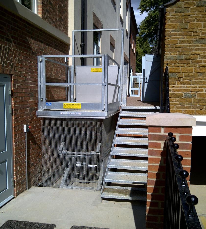 The lift is fitted with a gate, handrails and a goal post barrier to protect against falling from the upper level.