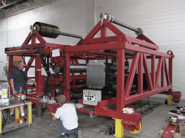 The process includes: (1) placing and stressing the steel strands in the casting bed, (2) placing self-consolidating concrete (SCC) in the bed, and (3) using a special machine to place the CFRP grid
