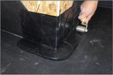 8) Once the first corner section is complete roll the taped area with hand roller.