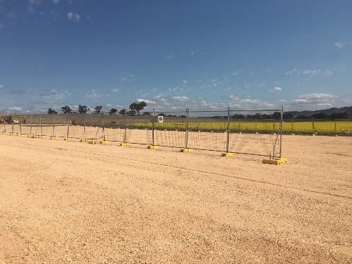 On the day of the inspection, temporary barrier fencing was being installed around the