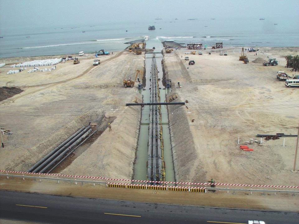Figure 2. Pipeline bundle reaches the sea. Figure 3. 74 m long pipe string being lowered onto transport bogies in cofferdam at tunnel entrance. type of support.