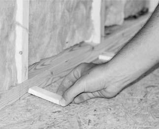 STEP 4 The floor shims are critical to ensure best results. Place 1/4 shims on the floor in front of sole plate (Fig 3.1). Install the first row of drywall vertically against the wall (Fig 3.2).