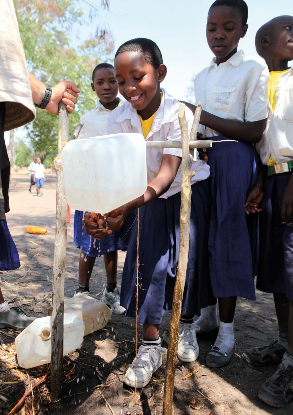 Schoolchildren practise handwashing with soap using the