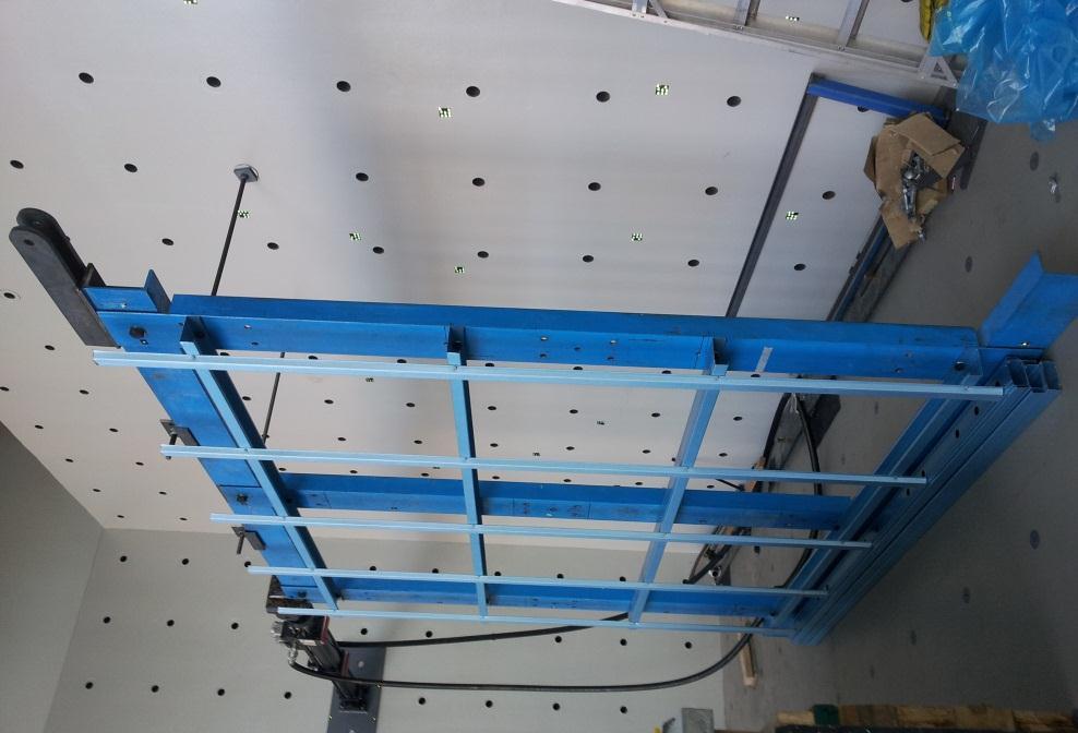 to the floor of the Lab; and the top was restrained in the out of plane direction for stability. The load was applied at the top of the loading frame via a hydraulic actuator.