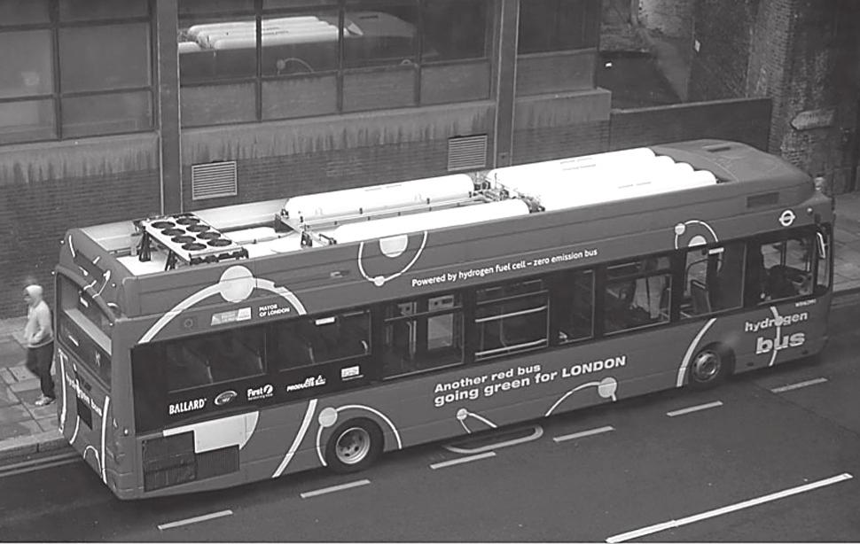 (c) The photograph shows one of the new buses for London. The bus uses hydrogen as a fuel. There are six hydrogen fuel tanks, which can be seen on the roof of the bus.