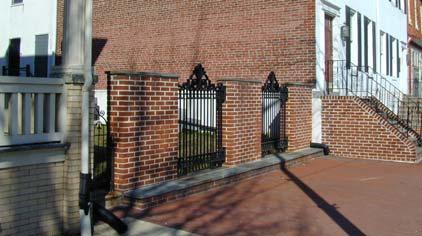 In areas where buildings have been built up against the sidewalk, however, fences have formed part of the street edge and sometimes are as high as six feet.
