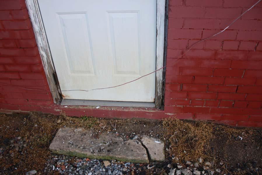 Continuous exposure to moisture around the east and south side of the building has help to rot wood door surrounds and deteriorate the