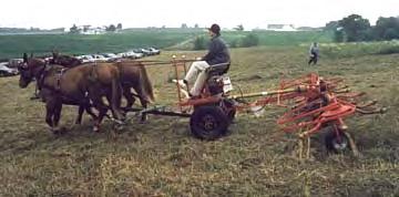 This machine is called a "tedder". The yellow teeth spin around and flip the cut grass up and fluff it to help it dry faster.
