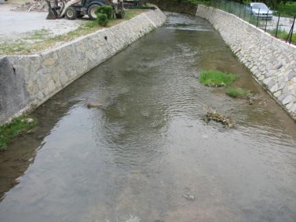 Channel predominantly affected by one or more of the following: regrading, reinforcement, culvert, berm, or clear evidence of dredging causing major change in width/depth ratio.