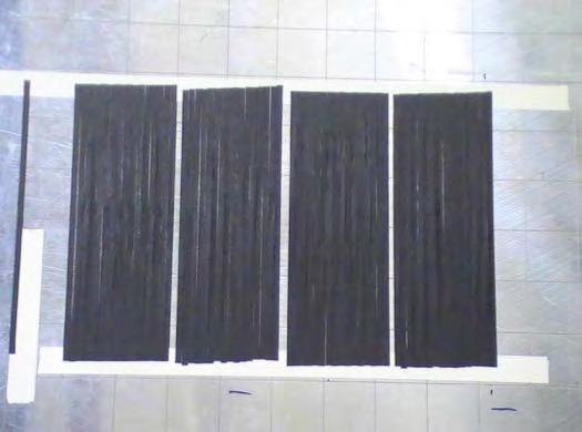 Figure 1 Four test patches of carbon fiber tow. Each is 16 tows wide. To measure tow placement data we use a single off-the-shelf laser sensor.