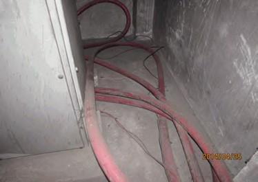 Excess HT cables coiled (not arranged) and laid on floor inside transformer room. Finding #: E- 7 Cable laid directly on concrete floor.