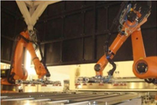 The picture at right shows a twin robot layout picking up and transferring flat metal blanks as part of a manufacturing system.