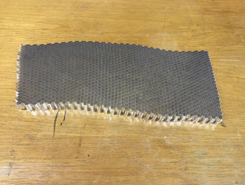 The cured hybrid FRP composite was removed from the hot press machine once the temperature of the material dropped to less than 66 C. (a) Figure 1.