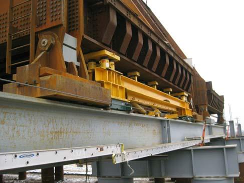 closures. The horizontal sliding of the trusses was accomplished using a push/pull frame and reaction sled (see Figure 5). load to the track beams with (2) 3 1/4 inch Diameter 80 ksi pins.