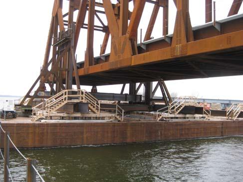 The support of the jacking towers (for all but one barge pair) was provided by a spine beam system that also linked together the dual 35 foot by 195 foot by 10 foot barges.