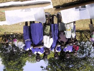 7 Collecting water from a shallow well, Nyakach, Kenya, for
