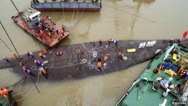 The capsized cruise ship was hoisted out of the waters of the Yangtze river on Friday evening (5