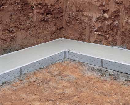Partially backfill outside of footing with appropriate stone, apply geotextile or filter fabric as illustrated (right) and complete backfilling with stone.