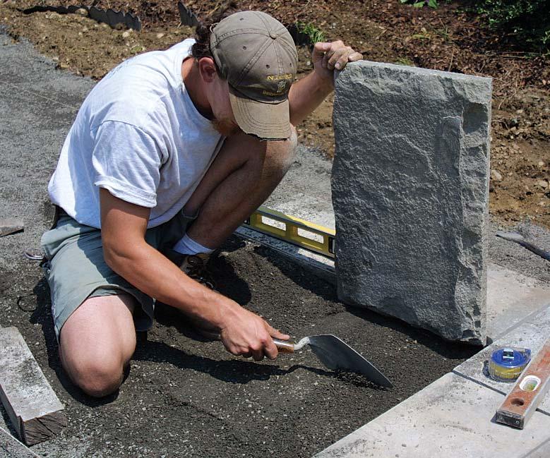 Read the bottom of the stone and level the top. Adjust the base so that the entire bottom of the stone is in contact with the stone dust.