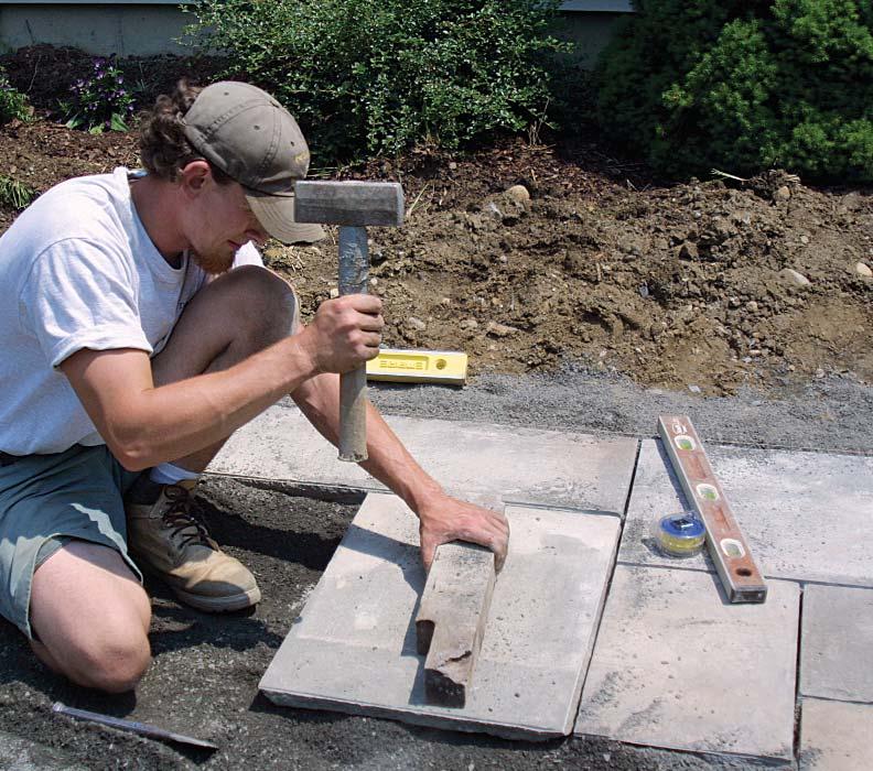 To make sure that the stone is sitting in plenty of dust, use a trowel and chisel to work dust in around the edges.