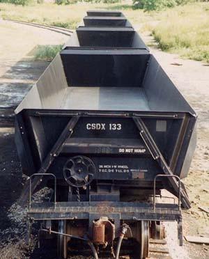 Side dump rail cars sprayed with black OR70SS on the interior bottoms to