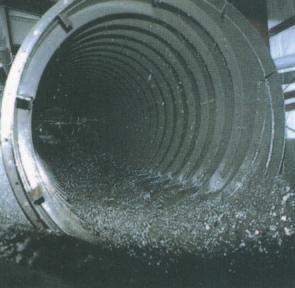 top of the flowing stream. The shale, which is heavier, sinks to the bottom and is carried by the scrolls back out of the top end of the barrel. The effective range for separation is between 1.