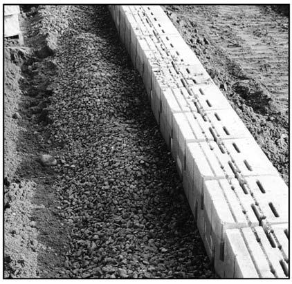 7 VERSA-LOK Standard Wall Construction Drainage Materials Beginning at the level of planned grade in front of the wall, place drainage aggregate (3/4-inch clear, free-draining, angular gravel)