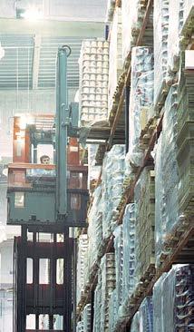 They are often supported by more conventional handling devices, which deposit and pick up pallets at the ends of the racking aisles.