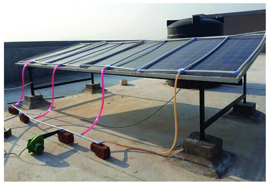 Photographic view of cooling arrangement Instrumentation Sixteen calibrated K-type thermocouples were fixed at typical locations above and below the photovoltaic panel surface to measure the glass