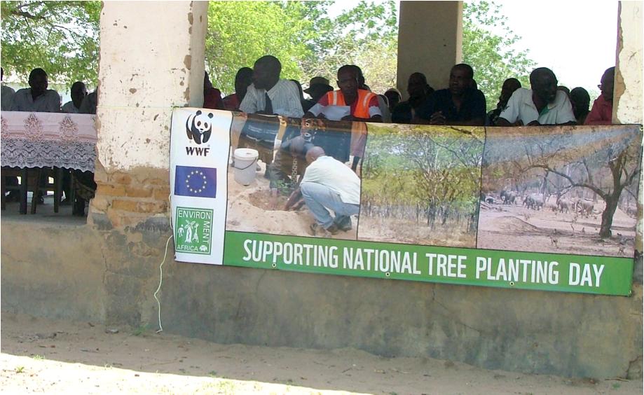 Delegates sitting behind a banner at a National Tree Planting Day in Mudzi District The European Commission may wish to publicise the results of Actions.