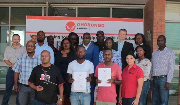 (In front: First of ten (seven not in picture) employees, who received their Deeds of Sale from the Otavi Town Council.