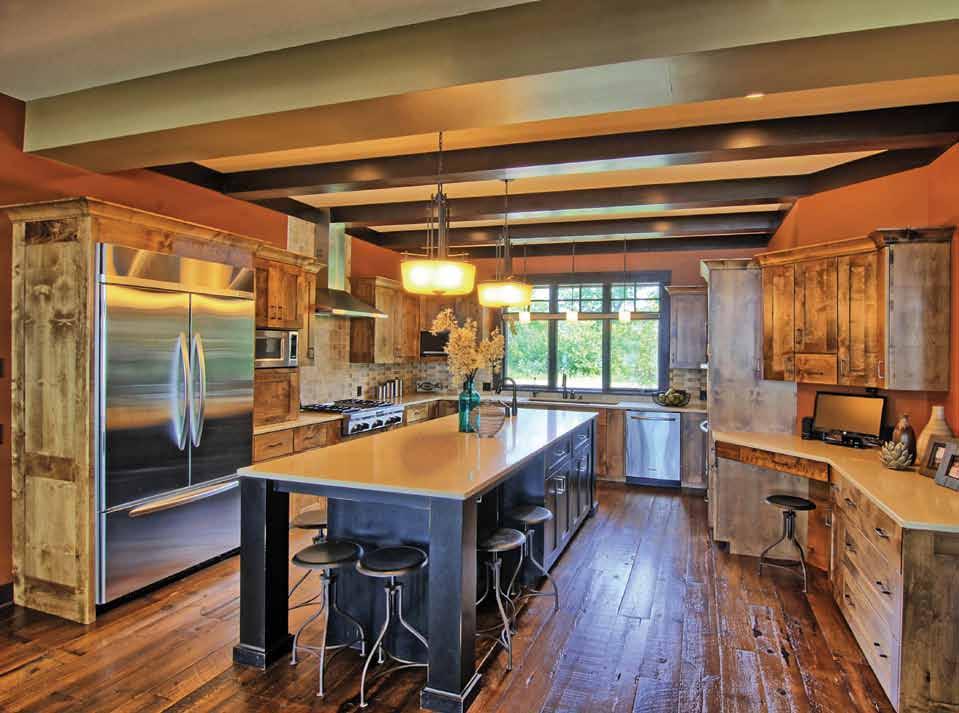 BELOW: Quartz countertops and barn wood floors warm the kitchen filled with all life s modern necessities.