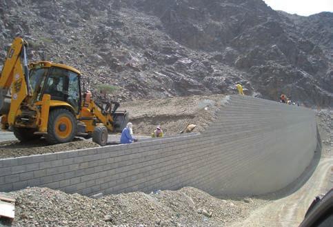 The TensarTech TW1 Wall System consists of pre-cast concrete modular facing blocks in combination with Tensar geogrids which reinforce the soil mass behind.