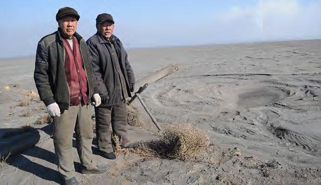 Neodymium Miners Victims of the West s Obsession with Green Villagers Su Bairen, 69, and Yan Man Jia Hong, 74, stand on the edge of the six-mile-wide toxic lake in Baotou, China that has devastated