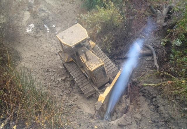 Striking Utilities Is Dangerous & Costly Bulldozer clearing brush from flood