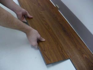 Insert the tongue side into the groove side of the previous row at a low angle and rotate downward until plank is flat with the substrate. 7. To install the second plank in the second row.
