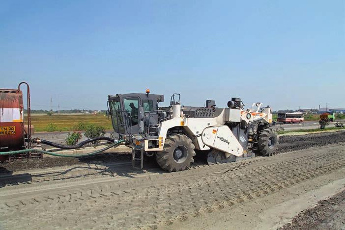 Behind the wheeled machine, various heavy duty Hamm compactors compacted the prepared base course.