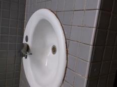 sinks on both sides of the restroom are rusted around the rims and the caulk has deteriorated around the sinks