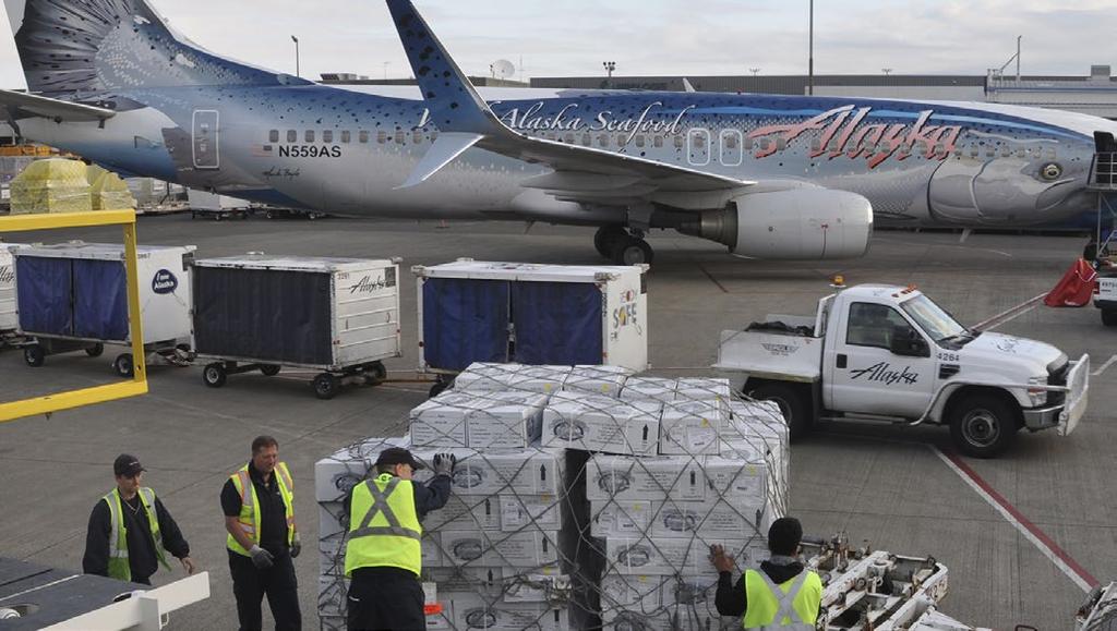 Workers unload a salmon delivery from Alaska, transported by Alaska Air Cargo. Anchorage and/or Fairbanks.