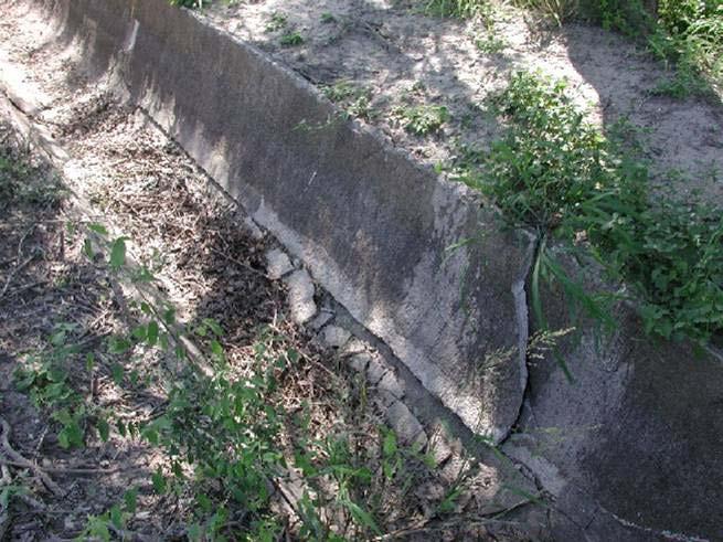 8 Figure 8. This canal has major damage to the right side wall and a large crack (D) which will eventually result in the wall falling into the canal.