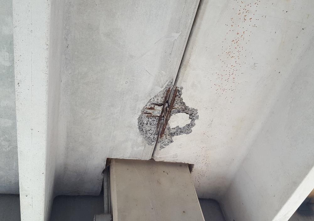 CORROSION RELATED SPALL AT A SHEAR CONNECTION FAILED CONCRETE AT A DOUBLE-TEE FLANGE CORNER Precast parking garages are an economical solution to cast-in-place concrete