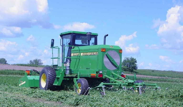 Figure 1. Windrower with rear attached tedder for simultaneously cutting, conditioning and placing crop in swath as wide as cutting platform.