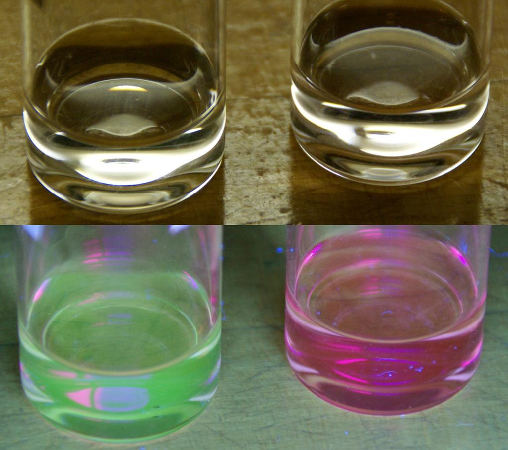 Dilute solutions of fluorescent dyes fluorescein (left) and Nile red (right) are indistinguishable in room light (top), but fluoresce with different colors under UV light (bottom) 2008 Matthew D.