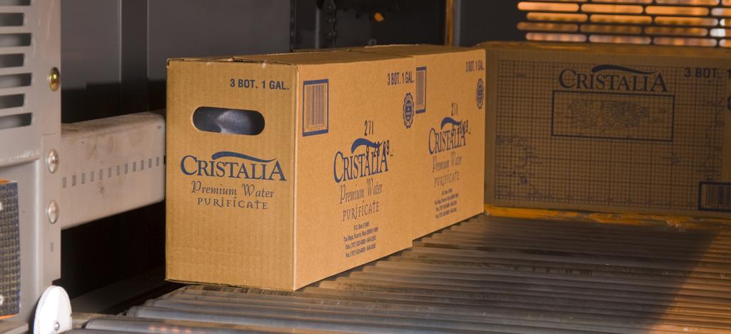 Conveyor brings cases from the one-gallon-jug production line to the infeed of the Alvey GS140 palletizer. According to Terrell, Cristalia experienced a six-month ROI with the new palletizer.