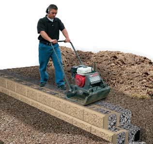 Compact in a direction that runs parallel with the wall for a minimum of passes with the plate compactor. Remove all excess material from the top of the blocks to prepare for the next course.